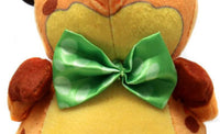 Close-up of the green satin polka-dot bow tie and plush body of the Nerdluck soft toy