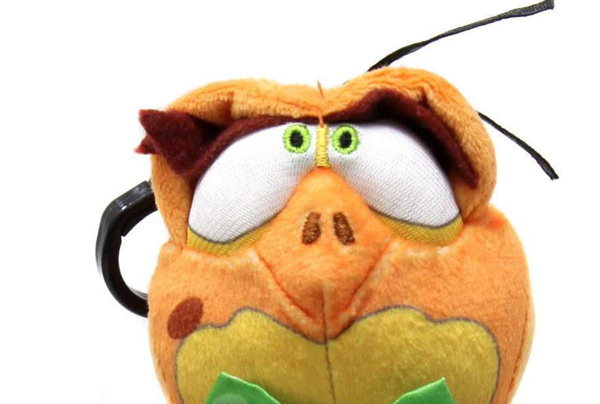 Close-up of the Nerdluck plush face showing embroidered eyes and the black plastic hanger clip
